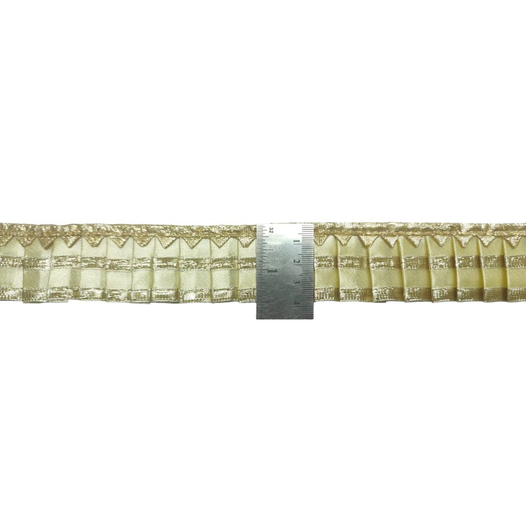 Decorative lace trim with a ruler for scale on a white background